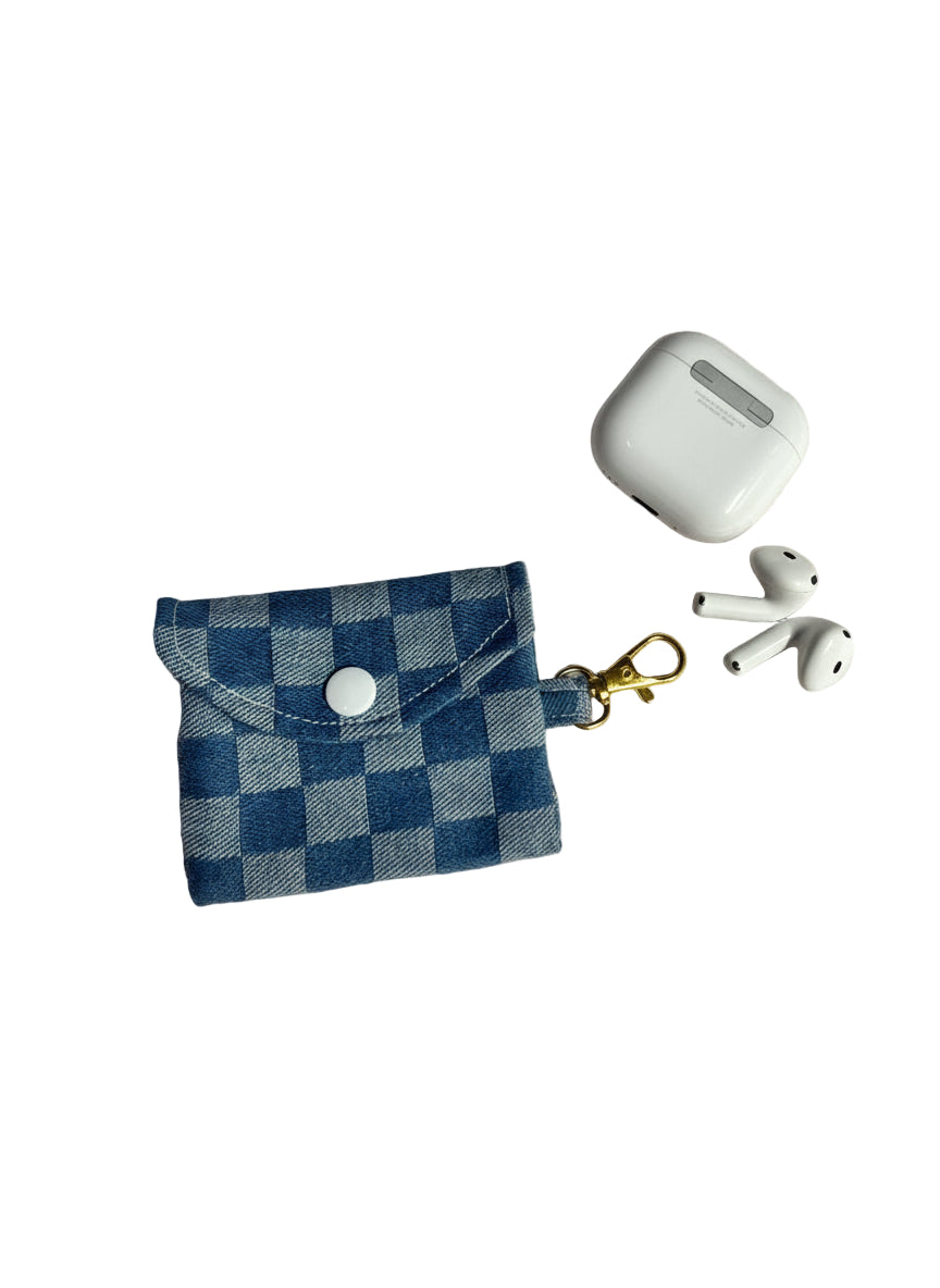 Blue checkered pouch with a keychain clip, white airpods case, and white airpods on a white background