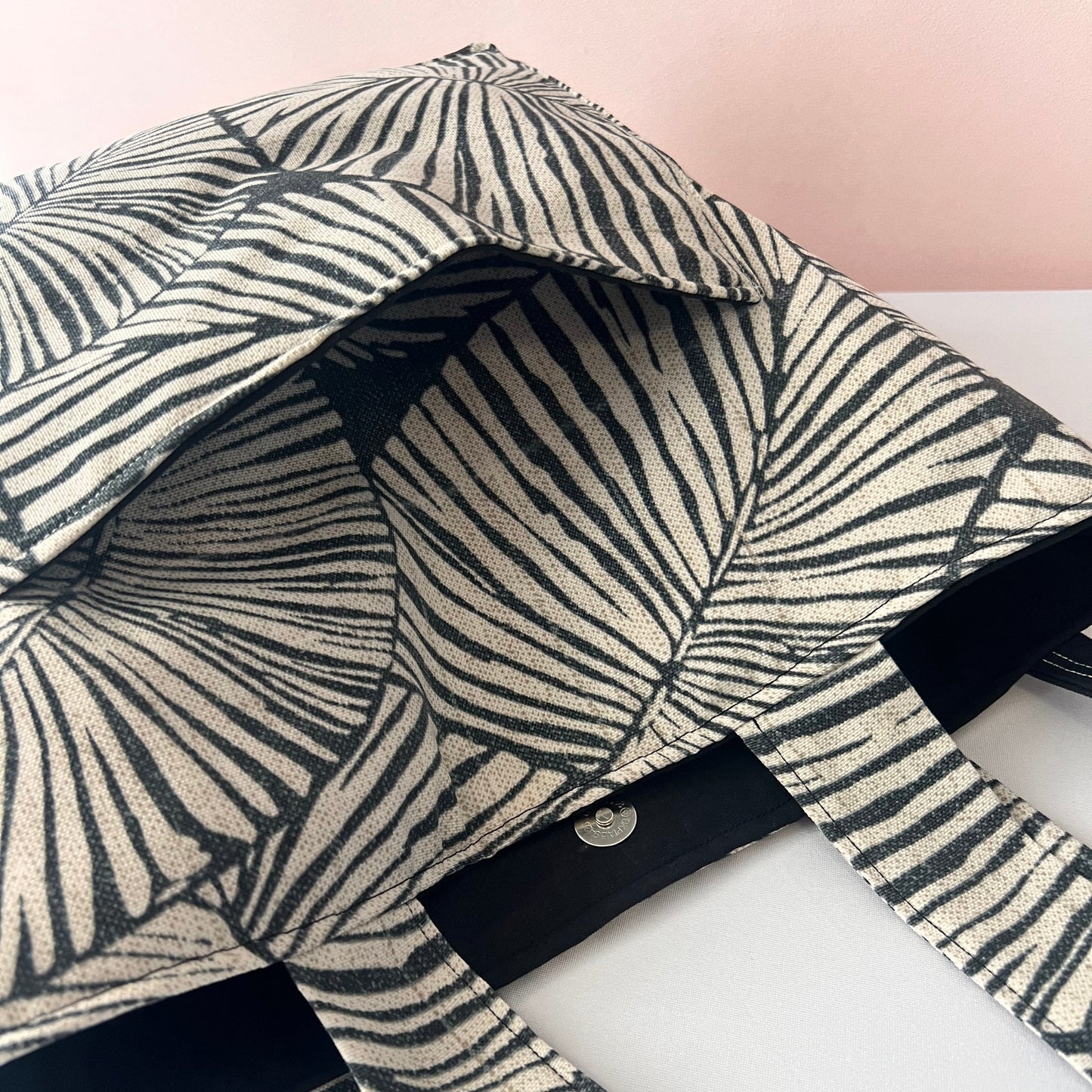 handmade black botanical tote bag with outside pocket