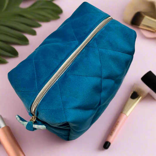 large_blue_velvet_makeup_bag_with_gold_zipper_and_ribbon_detail