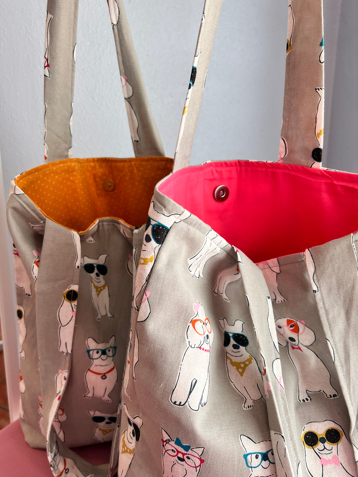 magnetic button closure on dog print shoulder tote bag in orange and red