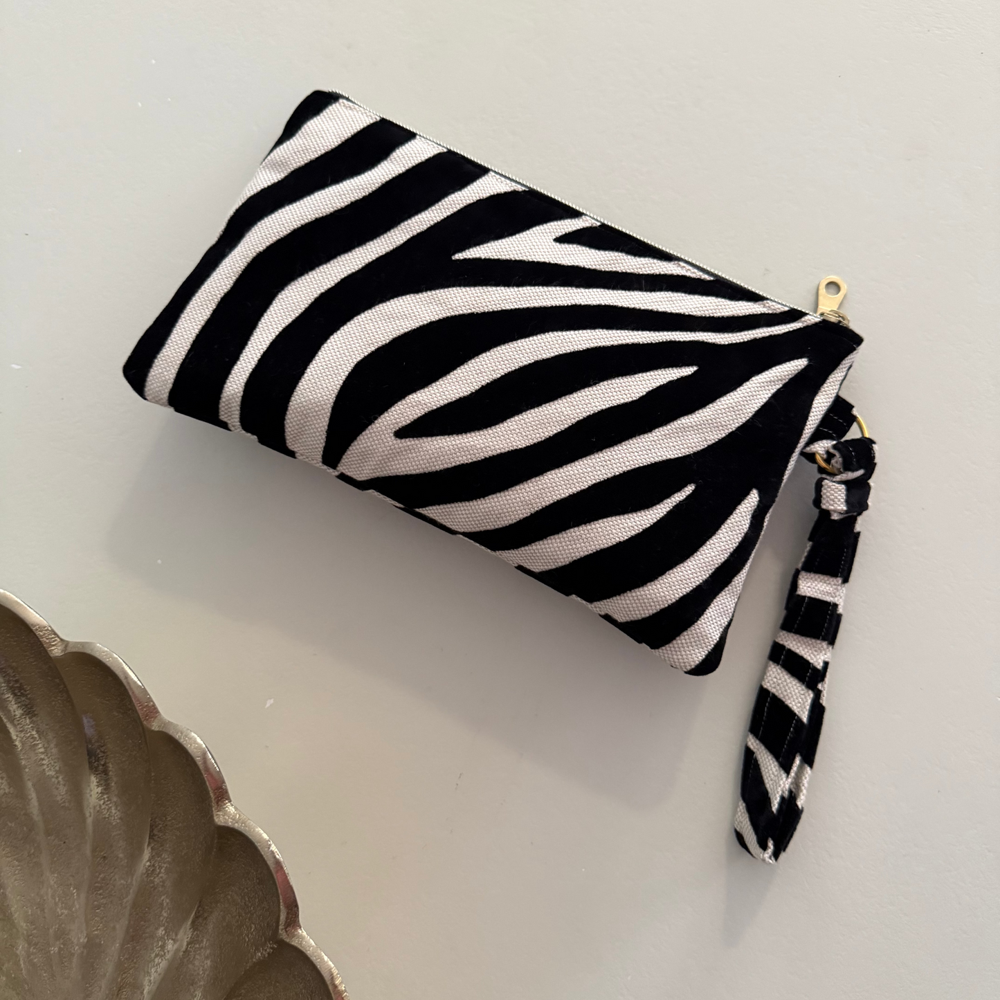 side view of black zebra print evening clutch bag